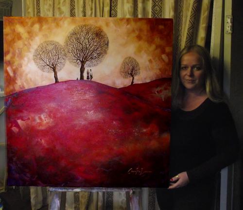 Cherie Roe Dirksen with her painting The Triad