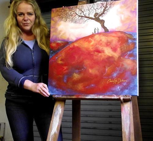 Cherie Roe Dirksen with her painting Reaching Out