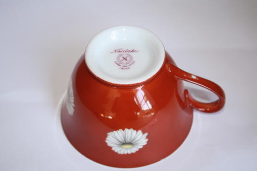 Noritake tea cup in red with daisies.