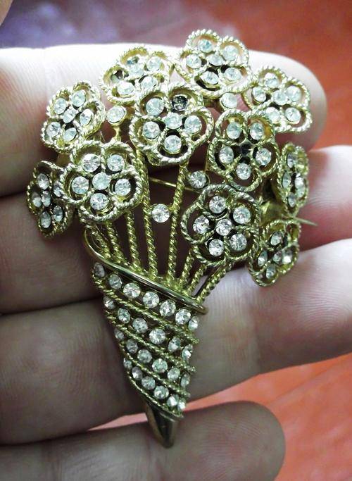 Brooches Costume jewellery brooch, gold coloured with stones for sale