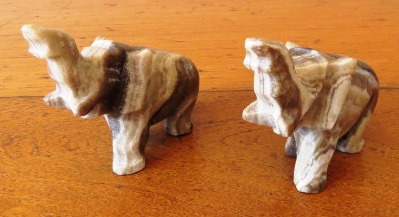 A pair of vintage hand carved marble onyx elephant figurines