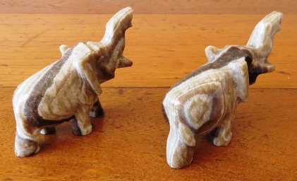 A pair of vintage hand carved marble onyx elephant figurines