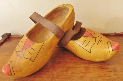 A very old pair of used Dutch clogs with leather straps