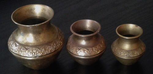 Set of three small brass vases