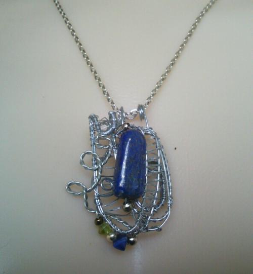 Lapiz lazuli stone pendant set in fine wire weaving by fern