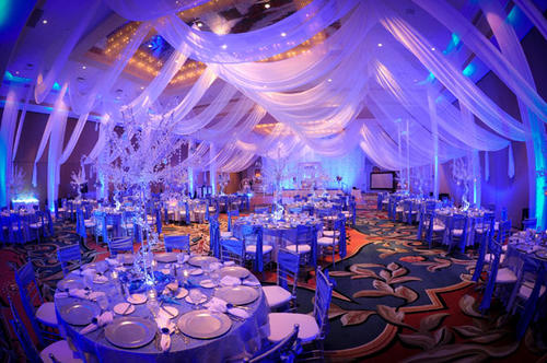  Specialty linens such as tablecloths, napkins, and chair covers are the perfect way to transform your wedding reception room for a reasonable price. The atmosphere is often set by the colors, textures, and patterns of the decorative linens or specialty linens. The influence of this decor can have a powerful impact as guests first walk into your wedding reception room. The layout of the tables and chairs as well as the linens covering them accounts for a large majority of the design weight of the actual room itself. Decor Essentials will help you in the process to make sure your event is perfect. We specialize in basic and custom fit chair covers for the hard to cover chairs. Colored linens can break up the white in your room. Too much white can affect your photography, by using colored linens or an over lay, will complement your wedding decoration. 