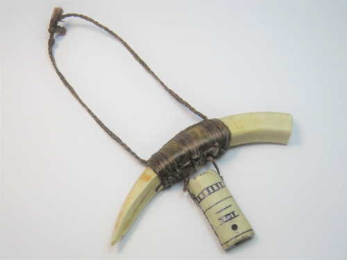 Foreign pendant made of tooth and bone